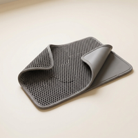 Flexible double-layer cat litter trapping mat on a warm neutral studio background
