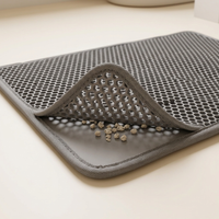 Close-up of the double-layer cat litter mat trapping clean litter between layers