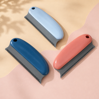 Reusable pet hair remover scraper shown in dark blue, light blue and coral color variations